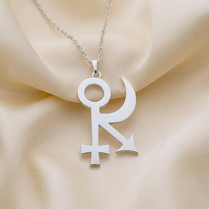 Close-up of the Sphinx Symbol Necklace pendant on cream satin
