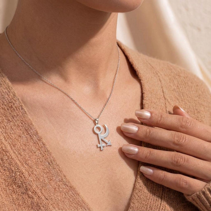 Sphinx Symbol Necklace worn with a textured brown cardigan