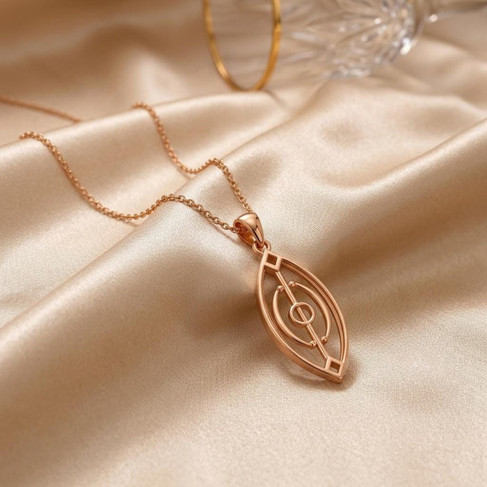 Rose Gold Plated Spirit Gate Pendant necklace displayed on champagne satin beside a glass vessel
