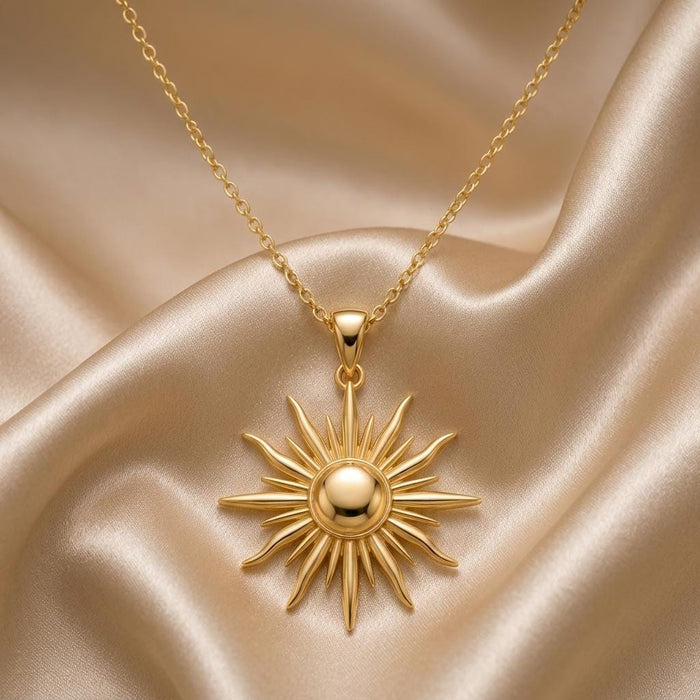 Gold Plated Silver Sun Ray Pendant Necklace with a raised rounded center and alternating pointed rays on champagne satin