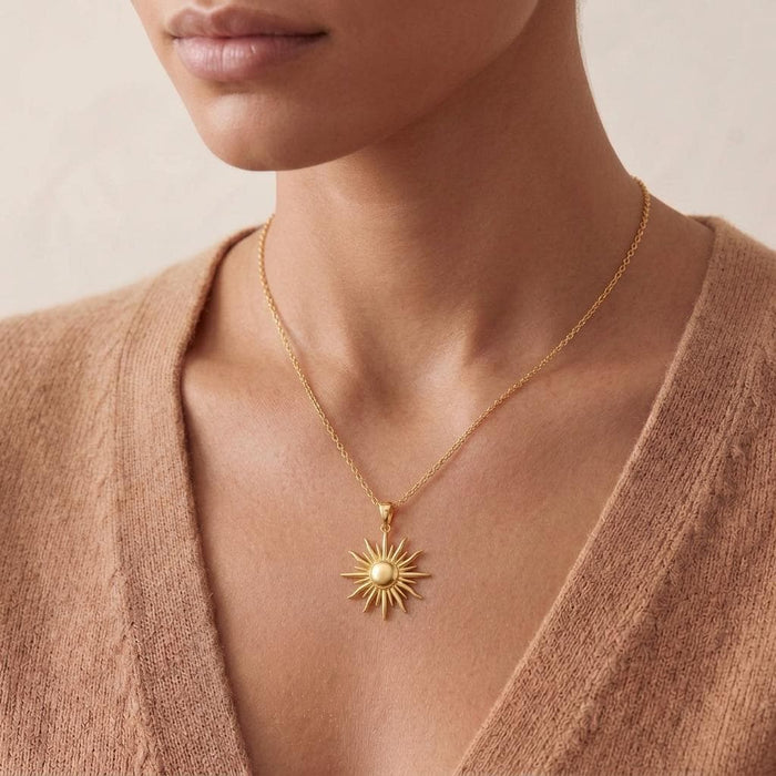 Close neckline view of a Gold Plated Silver Sun Ray Pendant Necklace with a raised rounded center and alternating pointed rays