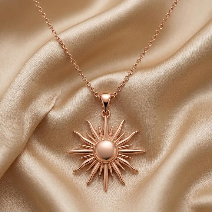 Rose Gold Plated Sun Ray Pendant Necklace displayed on champagne satin