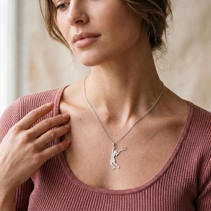 Tennis Player Necklace with full-body player silhouette worn with a pink ribbed top