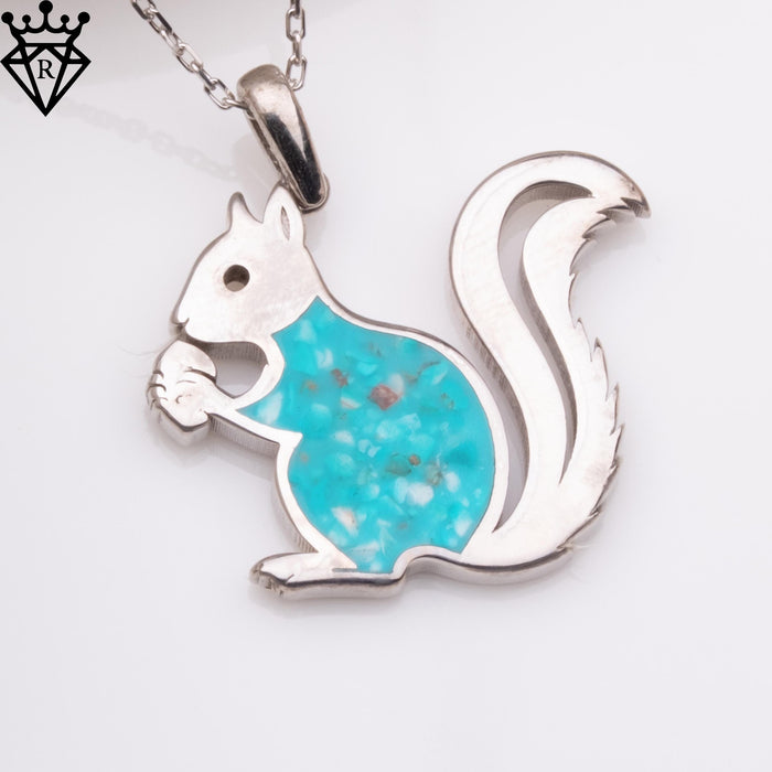 Angled squirrel charm showing the held nut and curled textured tail