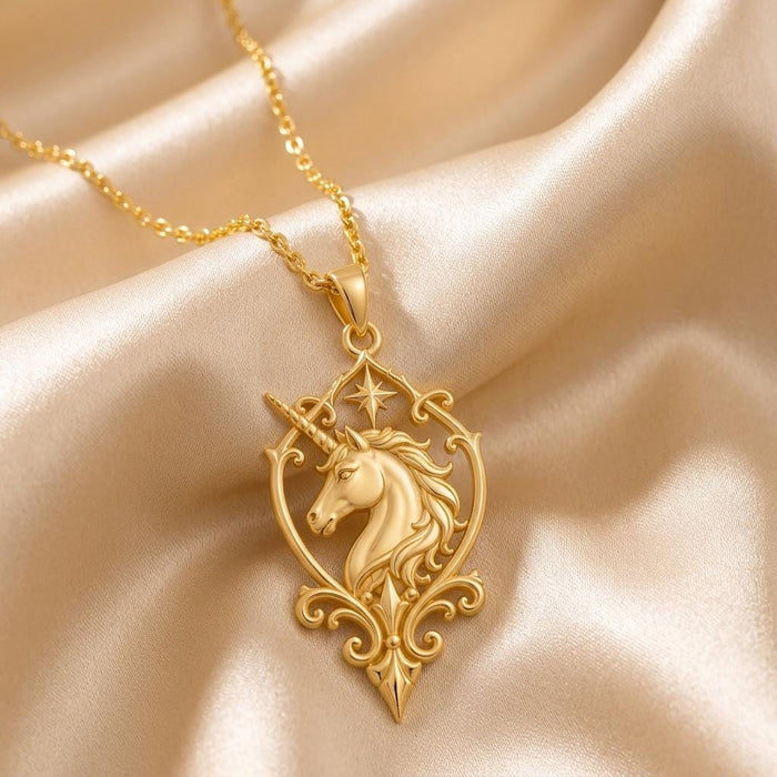 Gold Plated Silver Unicorn Sigil Necklace with a sculpted unicorn head, star detail, and scrollwork frame on champagne satin