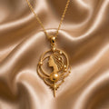 Gold Plated Silver Venus Aura Necklace with celestial profile, orbit arcs, stars, and lower star drop on champagne satin