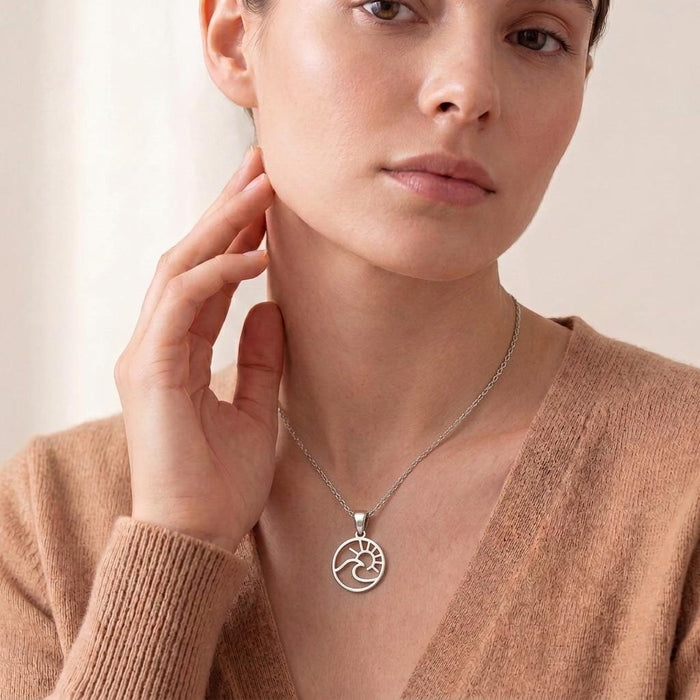 Front portrait of a model wearing the circular wave and sun pendant necklace