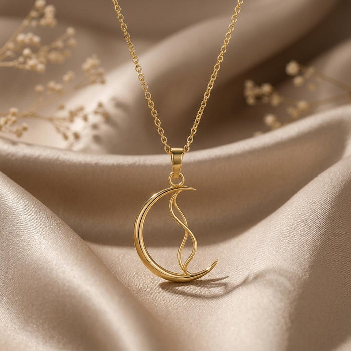 Gold-finish Whisper Crescent Pendant necklace on champagne satin with dried white flowers