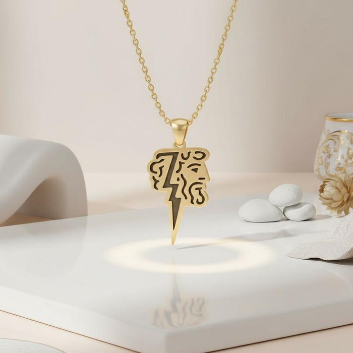 Gold Plated Silver Zeus Lightning Necklace on a white display surface with the stylized profile and lightning bolt pendant centered
