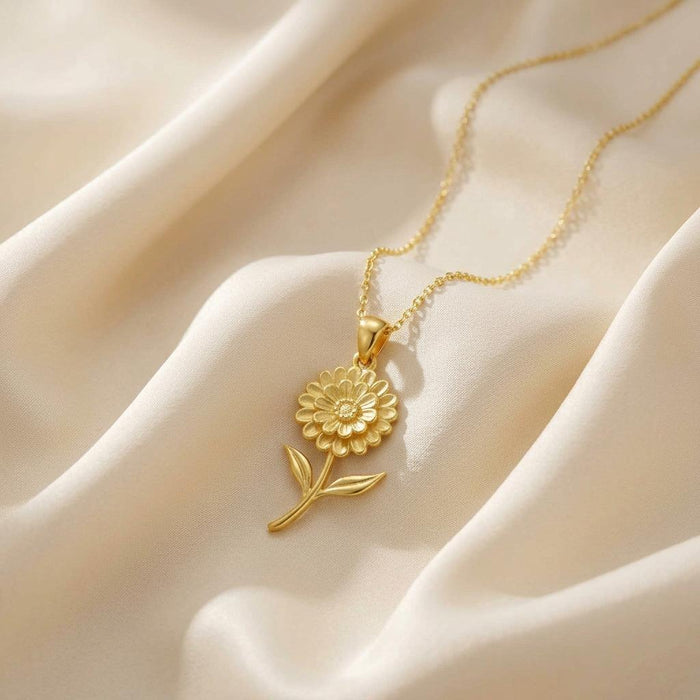 Gold Plated Silver Zinnia Flower Necklace with layered petals and two leaves on ivory satin