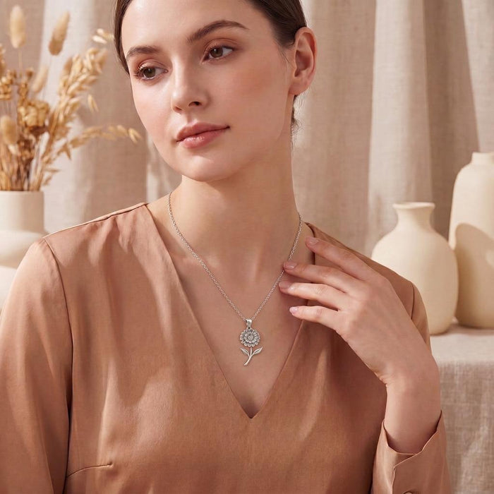 Silver Zinnia Flower Necklace worn with a V-neck blouse in a neutral interior