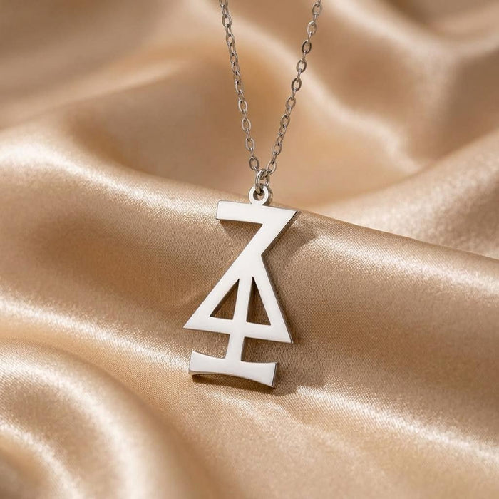 Close view of the Hansa Asteroid symbol pendant on champagne satin
