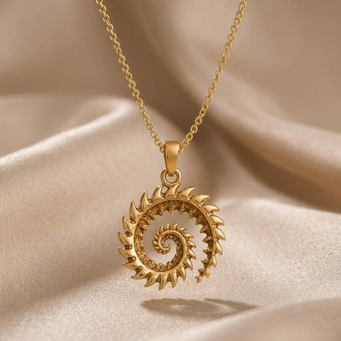 Gold Plated Silver Helicoprion spiral tooth pendant necklace on champagne satin