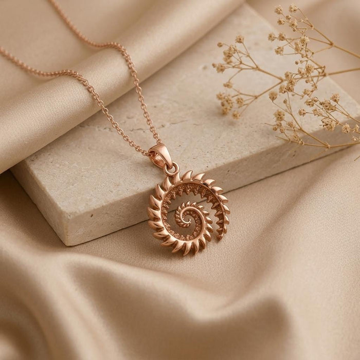 Rose Gold Plated Helicoprion spiral tooth pendant necklace on stone and satin