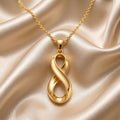Gold Plated Silver Infinity Fold Pendant Necklace on champagne satin