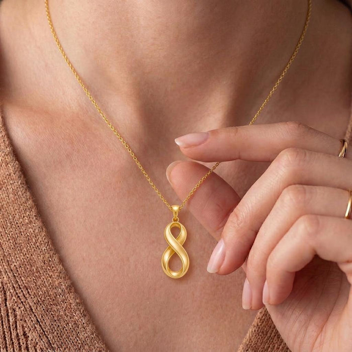 Close-up of a Gold Plated Silver Infinity Fold pendant worn at the neckline