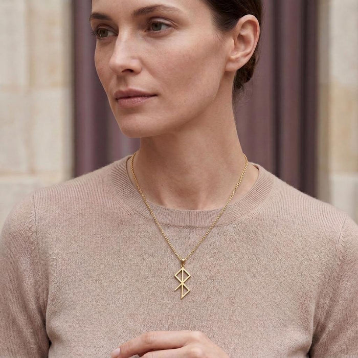Gold Plated Silver Inner Peace Rune Necklace worn over a beige crewneck knit
