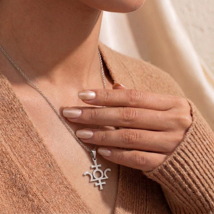 Model wearing a silver Isis Symbol Necklace with the pendant partly framed by her hand