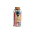 Glass jar filled with colorful rainbow party candles sealed with a cork lid.