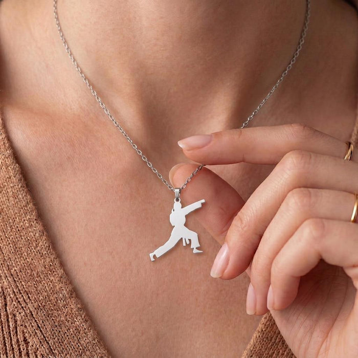 Karate Fighter Necklace in 925 sterling silver worn at the neckline with the pendant held by hand