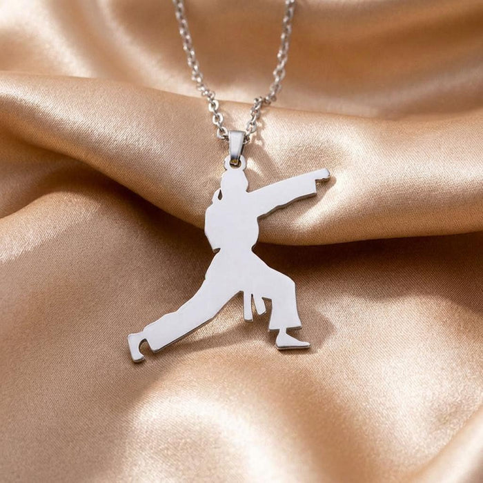 Close view of the Karate Fighter silhouette pendant on champagne satin