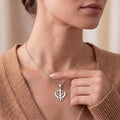 Model wearing a Silver Khanda pendant necklace with a warm knit top
