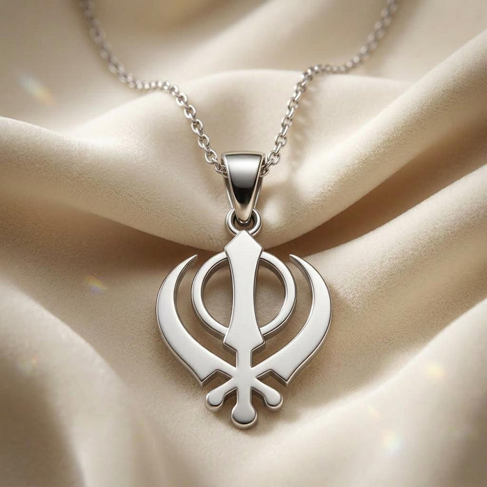 Close-up of a Silver Khanda pendant necklace on cream fabric