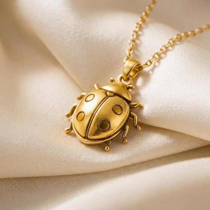 Close-up of the rounded ladybug pendant with circular spots on cream fabric