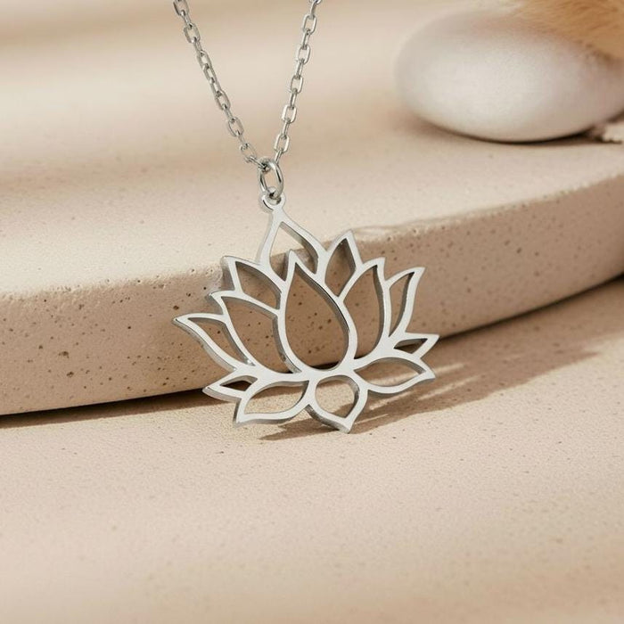Silver Lotus Flower Necklace close-up showing layered openwork petals on a stone surface