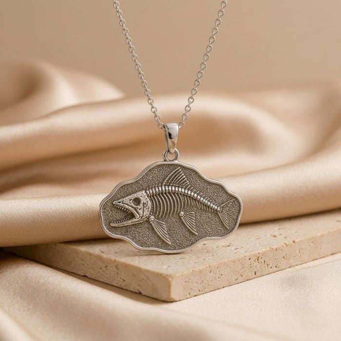 Silver-finish Leedsichthys Fossil Pendant Necklace with a textured fish skeleton plaque on satin and stone