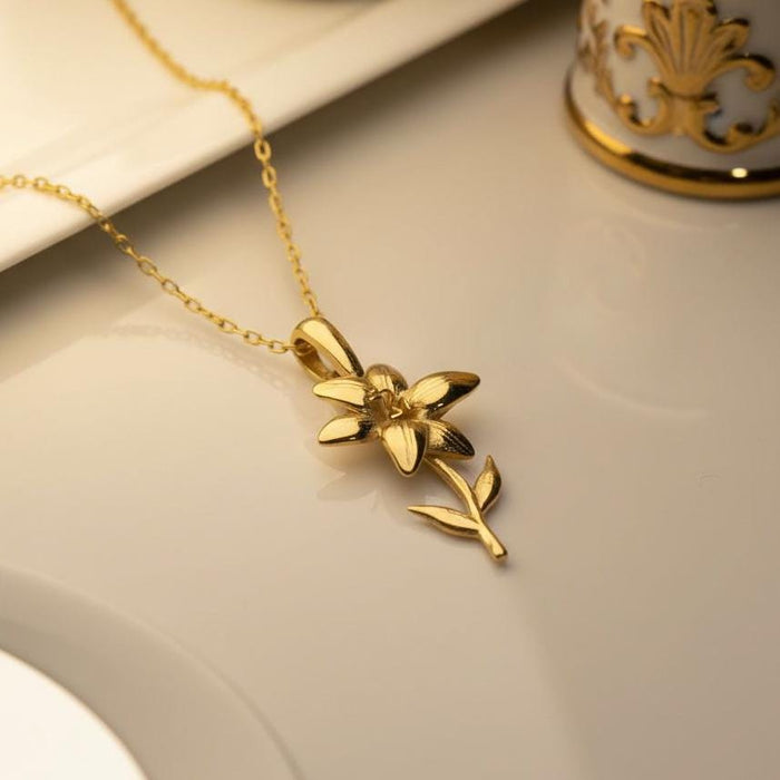 Gold Plated Silver Lily Flower Necklace displayed on a neutral surface