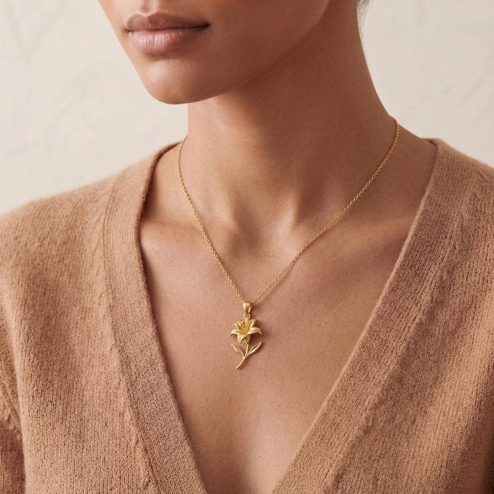 Close neckline view of a model wearing a Gold Plated Silver sculpted lily pendant necklace
