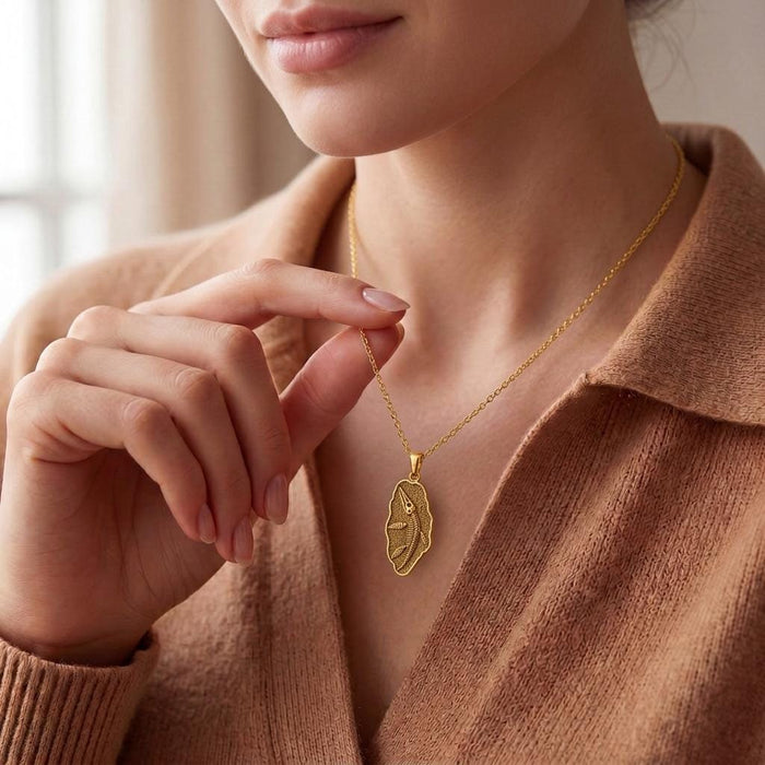 Gold Plated Silver Liopleurodon Fossil Pendant Necklace worn with a collared knit top