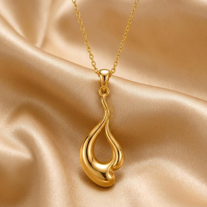 Gold Plated Silver Liquid Flow Pendant Necklace on champagne satin, showing the elongated openwork drop pendant