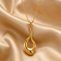 Gold Plated Silver Liquid Flow Pendant Necklace on champagne satin, showing the elongated openwork drop pendant