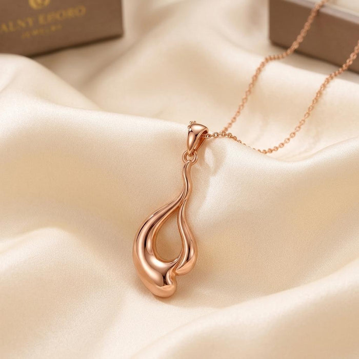 Rose Gold Plated Liquid Flow Pendant Necklace on ivory satin with the openwork flowing-drop pendant visible