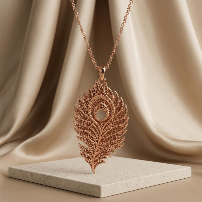 Rose Gold Plated Lunar Peacock Relic pendant necklace displayed upright on a pale stone platform