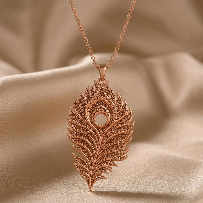 Rose Gold Plated Lunar Peacock Relic pendant necklace with layered openwork feather details on satin
