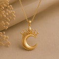 Gold Plated Silver Lunar Queen Pendant Necklace with crowned crescent pendant on beige fabric