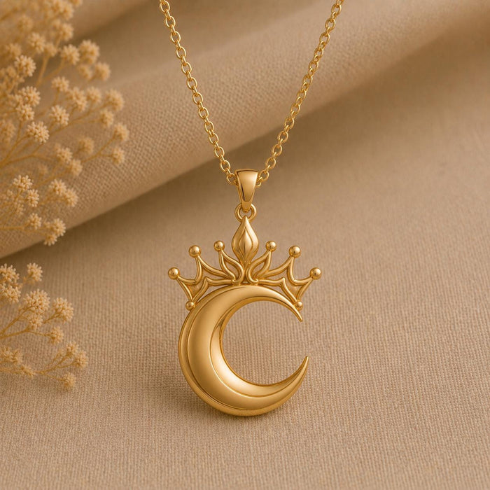 Gold Plated Silver Lunar Queen Pendant Necklace with crowned crescent pendant on beige fabric