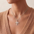 Lutetia Symbol Necklace in Silver worn at the neckline with a textured neutral V-neck top