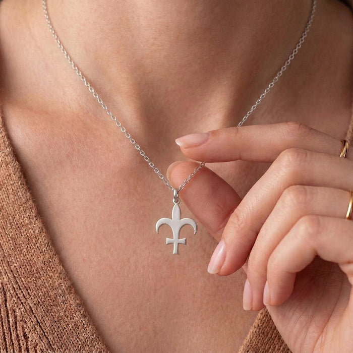 Close-up of the Silver Lutetia symbol pendant held at the neckline