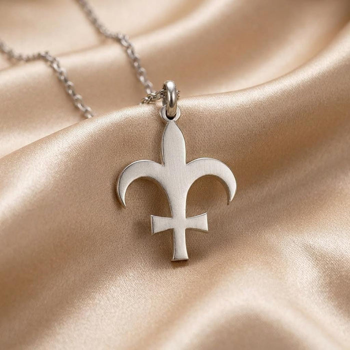 Silver Lutetia fleur-de-lis pendant necklace displayed on champagne satin