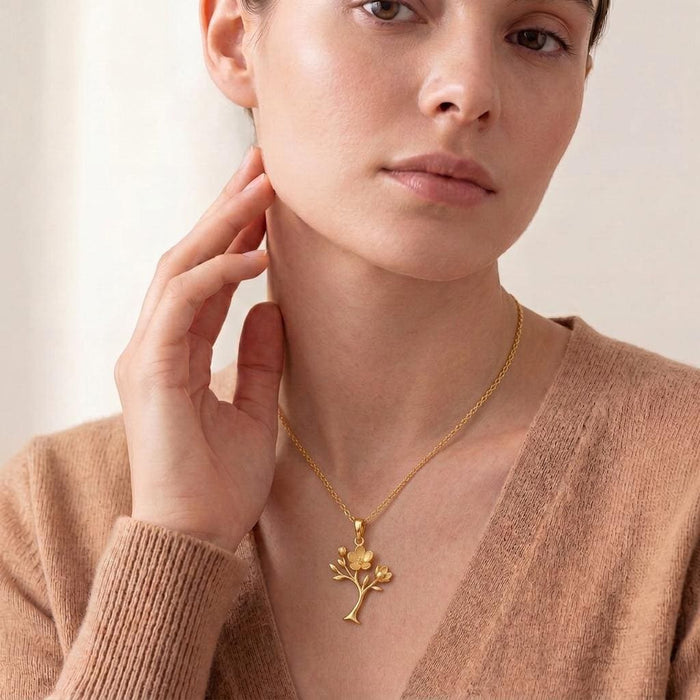 Model wearing the Gold Plated Silver Magnolia Soft Bloom Pendant with a V-neck knit