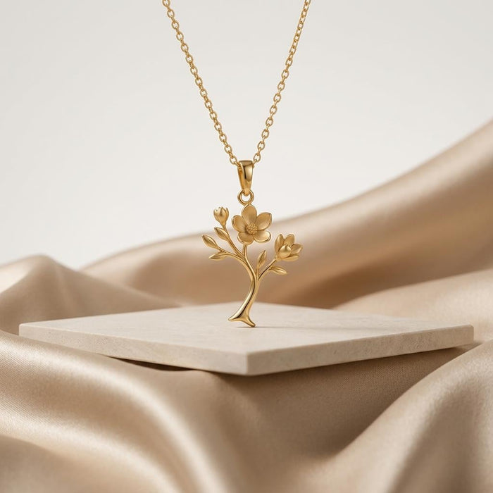 Gold-finish Magnolia Soft Bloom Pendant suspended above a pale stone display slab