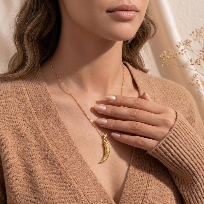Gold Plated Silver Mammoth Tusk Fossil Pendant Necklace worn with a deep V-neck knit