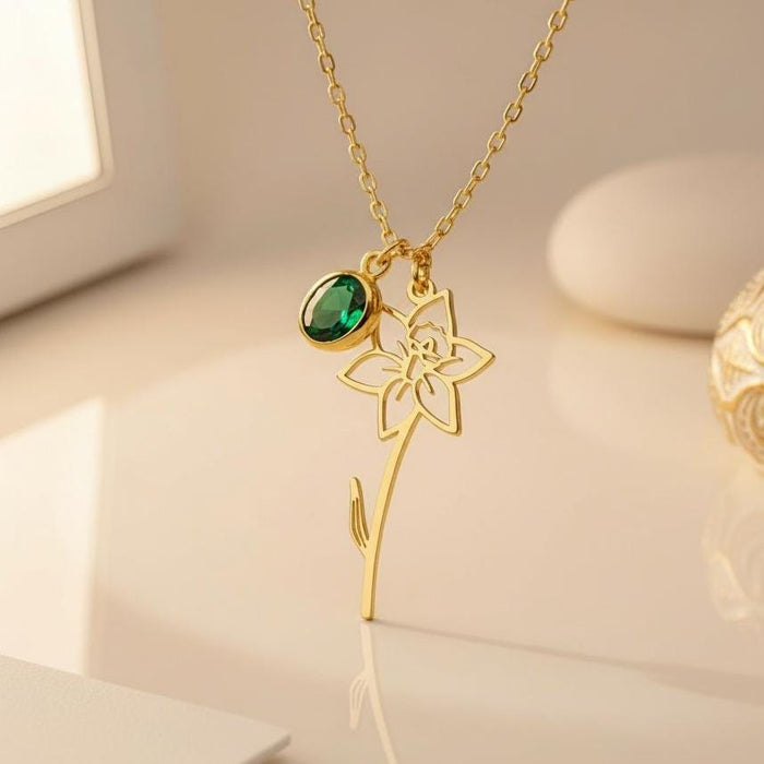 Close-up of a Gold Plated Silver openwork flower pendant with a green oval accent and curved stem