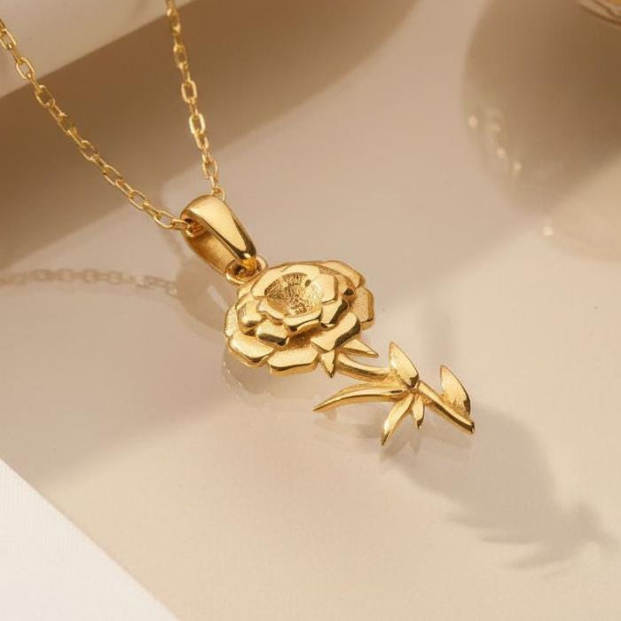 Close-up of a Gold Plated Silver layered flower pendant with a curved stem and pointed leaves