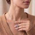 Silver May Birth Flower Necklace with a round purple stone accent worn with a warm neutral sweater