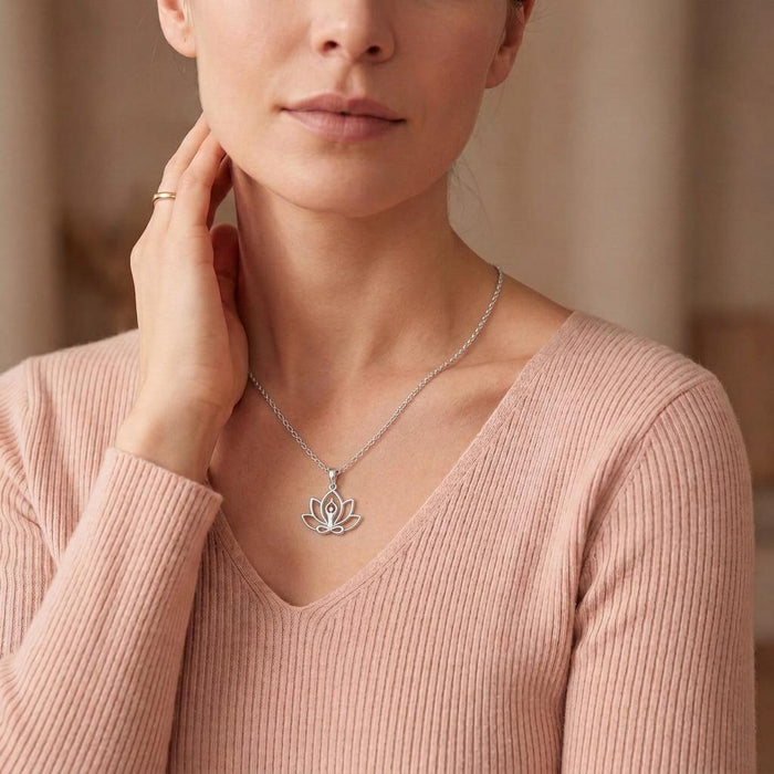 Silver Meditation Lotus Necklace worn with a blush ribbed V-neck top